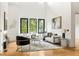 Bright living room with modern furniture, hardwood floors, and a large window showcasing the outdoor scenery at 187 Clay Se St, Atlanta, GA 30317
