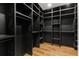 Spacious walk-in closet with custom black shelving and hardwood floors, offering ample storage and organization at 187 Clay Se St, Atlanta, GA 30317