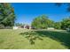 Spacious backyard featuring a lush lawn, storage buildings, and perimeter fencing at 2492 Bermuda Dr, Loganville, GA 30052