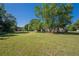 Wide backyard boasting a lush lawn, mature trees, and the home's rear exterior at 2492 Bermuda Dr, Loganville, GA 30052
