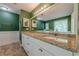 Well-lit bathroom boasts double sinks with granite countertops and white cabinets at 2492 Bermuda Dr, Loganville, GA 30052