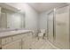 Bathroom featuring a single sink vanity, toilet, and glass shower with tile floors at 2492 Bermuda Dr, Loganville, GA 30052