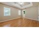 Bright bedroom features tray ceiling, ceiling fan, and beautiful hardwood flooring at 2492 Bermuda Dr, Loganville, GA 30052