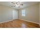 Bedroom with hardwood floors, ceiling fan and closet doors and large window at 2492 Bermuda Dr, Loganville, GA 30052