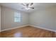 Bedroom with hardwood floors, ceiling fan, and a window for natural light at 2492 Bermuda Dr, Loganville, GA 30052