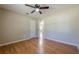 Bedroom with hardwood floors, ceiling fan, white door to hall and double closet at 2492 Bermuda Dr, Loganville, GA 30052