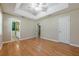 Bright bedroom features tray ceiling, ceiling fan, and beautiful hardwood flooring at 2492 Bermuda Dr, Loganville, GA 30052