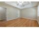 Bright bedroom features tray ceiling, ceiling fan, and beautiful hardwood flooring at 2492 Bermuda Dr, Loganville, GA 30052