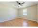 Bright bedroom with hardwood floors, ceiling fan, and a large window for natural light at 2492 Bermuda Dr, Loganville, GA 30052