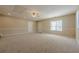 Spacious bonus room with neutral carpeting, ceiling fan, and natural light from the window at 2492 Bermuda Dr, Loganville, GA 30052