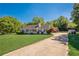 Attractive single-story home with a well-kept lawn, accented by a red flowering shrub and a paved driveway at 2492 Bermuda Dr, Loganville, GA 30052