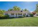 Charming single-story home with a well-manicured lawn, cozy front porch, and classic red shutters at 2492 Bermuda Dr, Loganville, GA 30052