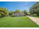 Traditional home featuring a spacious front yard, a classic ranch design, and a long driveway at 2492 Bermuda Dr, Loganville, GA 30052