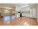 Kitchen with white cabinets, black appliances, and wood floors that opens up to the living room at 2492 Bermuda Dr, Loganville, GA 30052