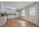 Efficient kitchen with white cabinets and appliances, hardwood floors, and direct access to the backyard at 2492 Bermuda Dr, Loganville, GA 30052