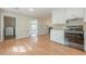 Kitchen and breakfast area with white cabinets, black appliances, and wood floors at 2492 Bermuda Dr, Loganville, GA 30052