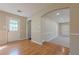 Living room with wood floor, neutral walls, and a white door with glass at 2492 Bermuda Dr, Loganville, GA 30052