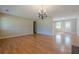 Large living space with hardwood flooring, an elegant chandelier, and ample natural light, ideal for entertaining at 2492 Bermuda Dr, Loganville, GA 30052