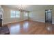 Open-concept living room with hardwood floors, a decorative fireplace, and a view of the front entrance at 2492 Bermuda Dr, Loganville, GA 30052