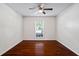 An empty bedroom features beautiful hardwood floors, a ceiling fan, and a window at 3701 Essex Ave # 2, Atlanta, GA 30339