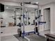 This is an image of a home gym with a power rack, weights, bench, and mirrored wall for exercise at 3701 Essex Ave # 2, Atlanta, GA 30339