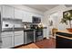 Clean kitchen with stainless steel appliances, white cabinets, and access to a bright dining area at 3701 Essex Ave # 2, Atlanta, GA 30339