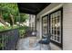 Cozy covered patio with black metal furniture and a textured rug, perfect for relaxing outdoors at 3701 Essex Ave # 2, Atlanta, GA 30339
