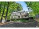 Expansive backyard view featuring a deck, manicured lawn, mature trees, and a well-maintained landscape at 4331 Volnay Ne Ct, Marietta, GA 30066