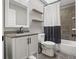 This bathroom features a granite countertop vanity with tile floors and a shower with black and white curtains at 4331 Volnay Ne Ct, Marietta, GA 30066