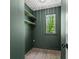 This closet space has light hardwood floors, light green walls and a window with a backyard view at 4331 Volnay Ne Ct, Marietta, GA 30066