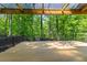 This deck features a wood floor, a black metal railing, and a view of the lush green forest at 4331 Volnay Ne Ct, Marietta, GA 30066