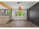 Modern dining area with stylish light fixture, shiplap accent wall, and bay window overlooking lush greenery at 4331 Volnay Ne Ct, Marietta, GA 30066