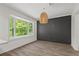 Modern dining area with stylish light fixture, shiplap accent wall, and bay window overlooking lush greenery at 4331 Volnay Ne Ct, Marietta, GA 30066