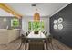 Modern dining area with stylish light fixture, shiplap accent wall, and bay window overlooking lush greenery at 4331 Volnay Ne Ct, Marietta, GA 30066