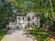 Charming white home with well-manicured lawn and driveway, surrounded by lush trees, showcasing curb appeal at 4331 Volnay Ne Ct, Marietta, GA 30066