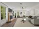 Bright living room with a fireplace, neutral decor, large windows, and modern furniture at 4331 Volnay Ne Ct, Marietta, GA 30066
