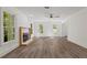 Bright living room with a fireplace, neutral decor, large windows, and hardwood floors at 4331 Volnay Ne Ct, Marietta, GA 30066