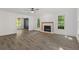 Bright living room with a fireplace, neutral decor, large windows, and hardwood floors at 4331 Volnay Ne Ct, Marietta, GA 30066