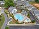 Resort-style community pool, clubhouse, and lounge area surrounded by lush greenery and manicured landscape at 1010 Fendley St, Woodstock, GA 30188