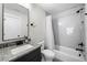 Well-lit bathroom featuring a granite countertop, updated fixtures, and a shower over tub at 1010 Fendley St, Woodstock, GA 30188