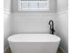 Bright bathroom featuring a white soaking tub and modern finishes at 1010 Fendley St, Woodstock, GA 30188