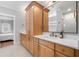 Bright bathroom featuring double vanity, quartz countertops, light wood cabinets, and neutral tile floor at 1010 Fendley St, Woodstock, GA 30188