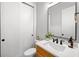 Clean bathroom with a wood vanity and modern fixtures at 1010 Fendley St, Woodstock, GA 30188