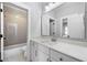 Stylish bathroom with white cabinets, quartz countertop, and tiled shower at 1010 Fendley St, Woodstock, GA 30188