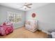 Bedroom with ceiling fan, natural light, and hardwood floors at 1010 Fendley St, Woodstock, GA 30188