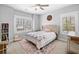 Bright bedroom with plush carpeting, accent rug, and a decorative bed frame and headboard at 1010 Fendley St, Woodstock, GA 30188