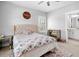 This bedroom offers neutral paint, a ceiling fan, and an ensuite bathroom at 1010 Fendley St, Woodstock, GA 30188