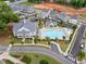 An aerial view of a community pool and amenity center surrounded by well-manicured landscaping in a neighborhood setting at 1010 Fendley St, Woodstock, GA 30188