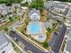 Overhead view of a community pool with surrounding lounge areas, set in a neighborhood with tree-lined streets at 1010 Fendley St, Woodstock, GA 30188