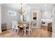 Elegant dining area, chandelier, hardwood floors, open to kitchen, great for Gathering gatherings and entertaining guests at 1010 Fendley St, Woodstock, GA 30188
